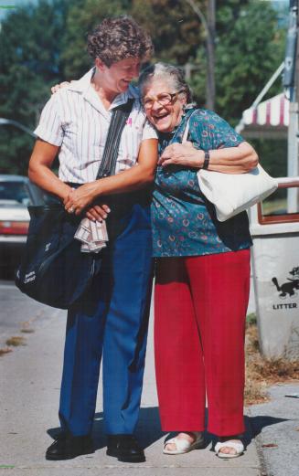 Many Thanks: Letter carrier Judy McIntyre is hugged by Mississauga resident Elizabeth Roberge, 83, who was happy to receive her pension cheque yesterday