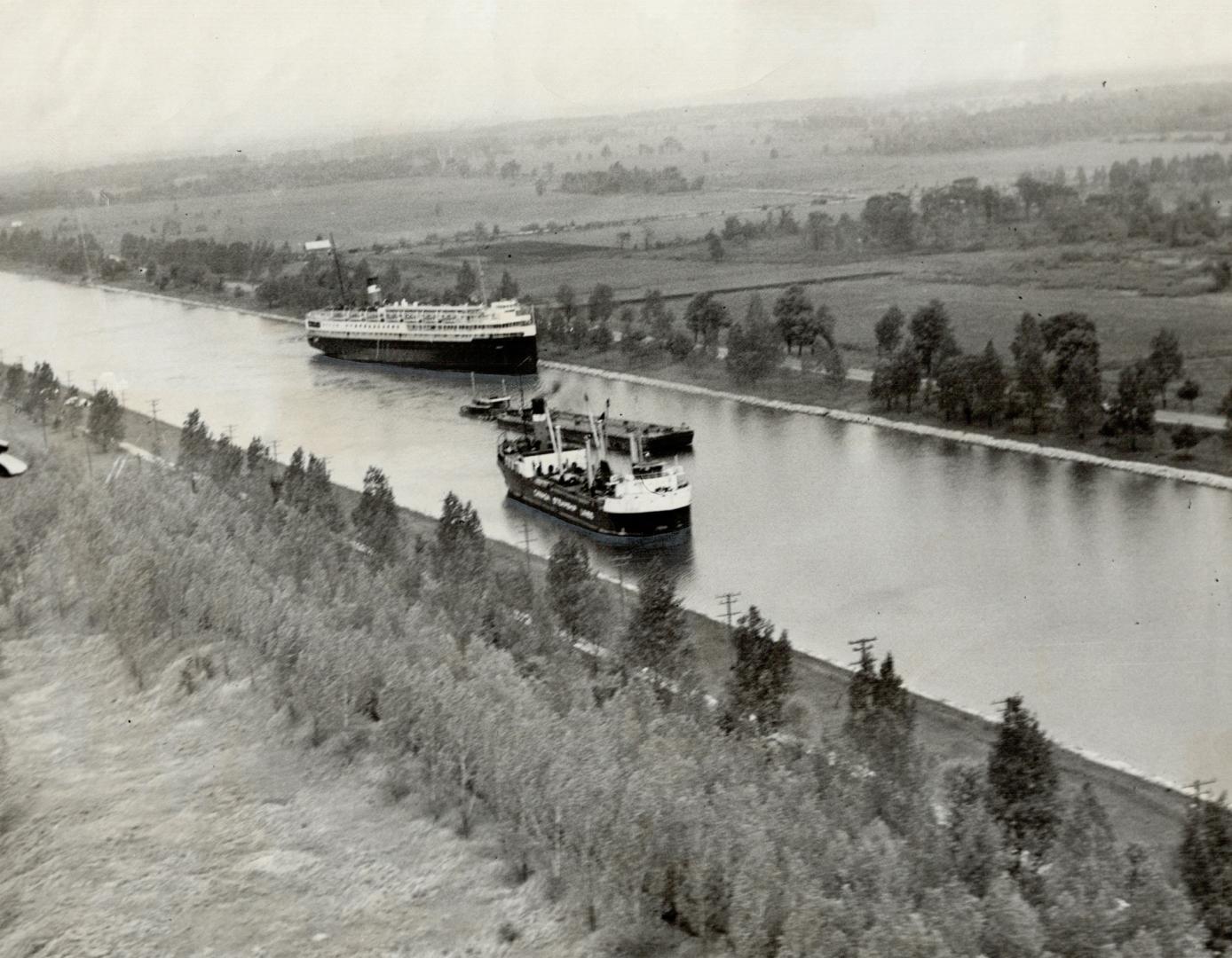 The Passenger ship Noronic is moored to the bank of the Welland canal while a tanker under steam moves past