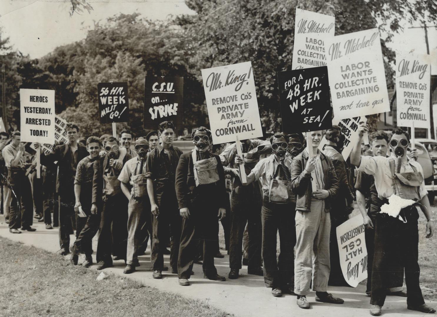 Victory Parade in which striking seamen wore newly arrived gas masks and carried signs was held through Cornwall streets after announcement that agree(...)