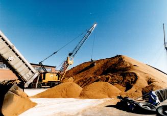 Loads of sweetness: Heavy equipment piles up tonnes of raw sugar at the Redpath Sugar refinery on Queen's Quay