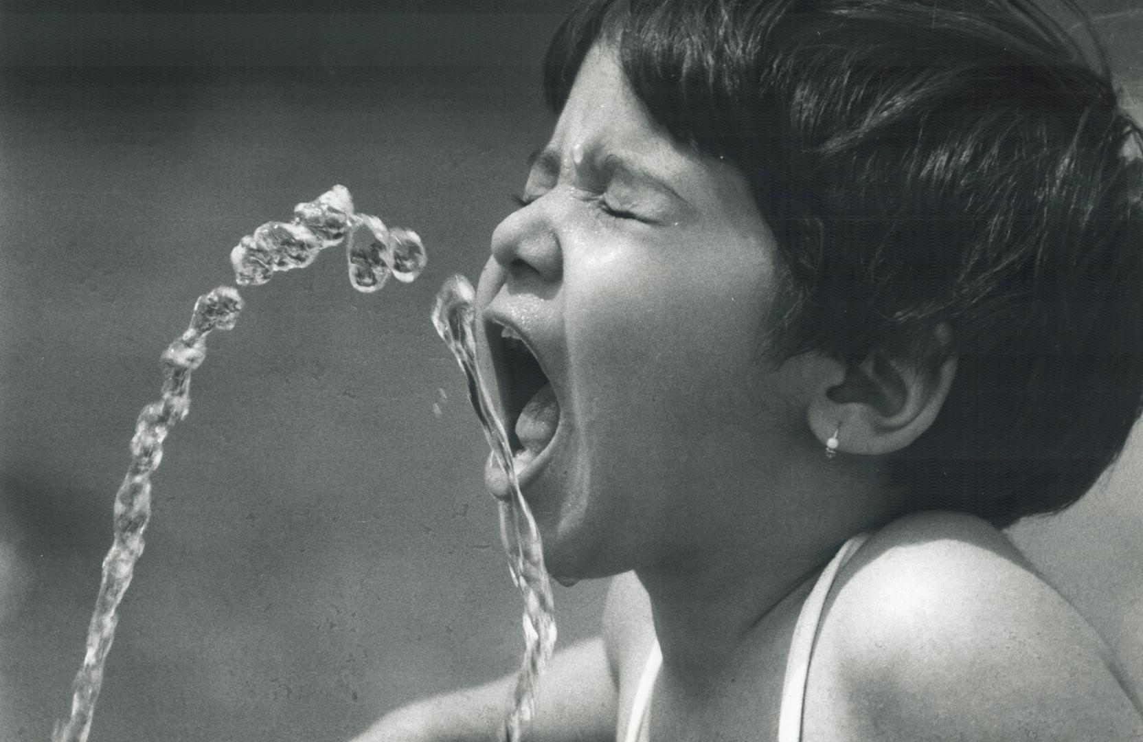 Diana Anand, 2, chasing a cool spray from a Sunnyside fountain