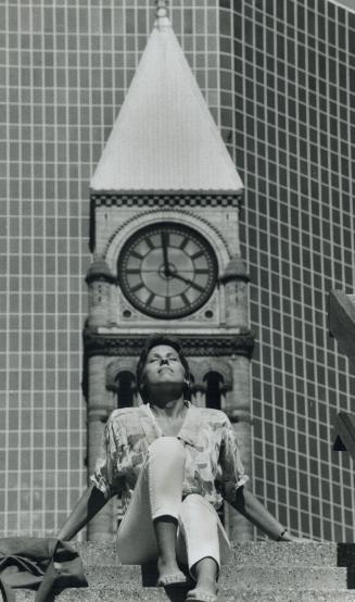 Sunbathing time, Julie Baksa looks as if she doesn't particularly care what time is showing on the Old City Hall clock, because for her it's sunbathin(...)