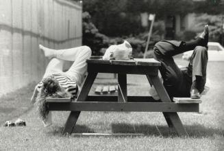 Siesta in Sync, Tracy Vousden and Michael O'Sullivan catch some rays and a few winks on a picnic bench after lunching in the park on Sherbourne St. so(...)