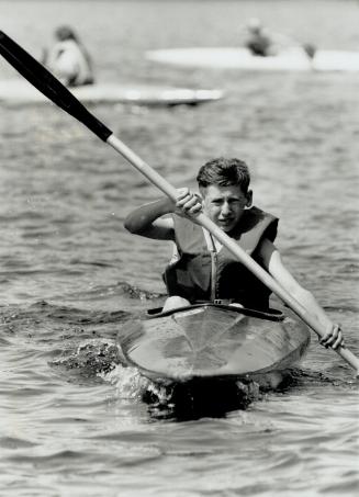 Going forward: Tim Belanger, 14, kayaks on Roseau Lake at Camp Oochigeas, where kids with cancer are equals who just want to enjoy the summer