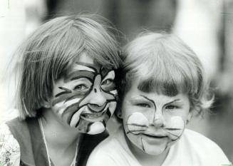 Animal antics, Erika Langman, 7, and her sister Susanna, 5, have their faces painted at the 25th anniversary yesterday of Camp Towhee, a camp in Hallb(...)