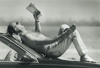 A place in the sun, David Fisher gets an early start on weekend sunning by stretching out on his car yesterday at Cherry Beach