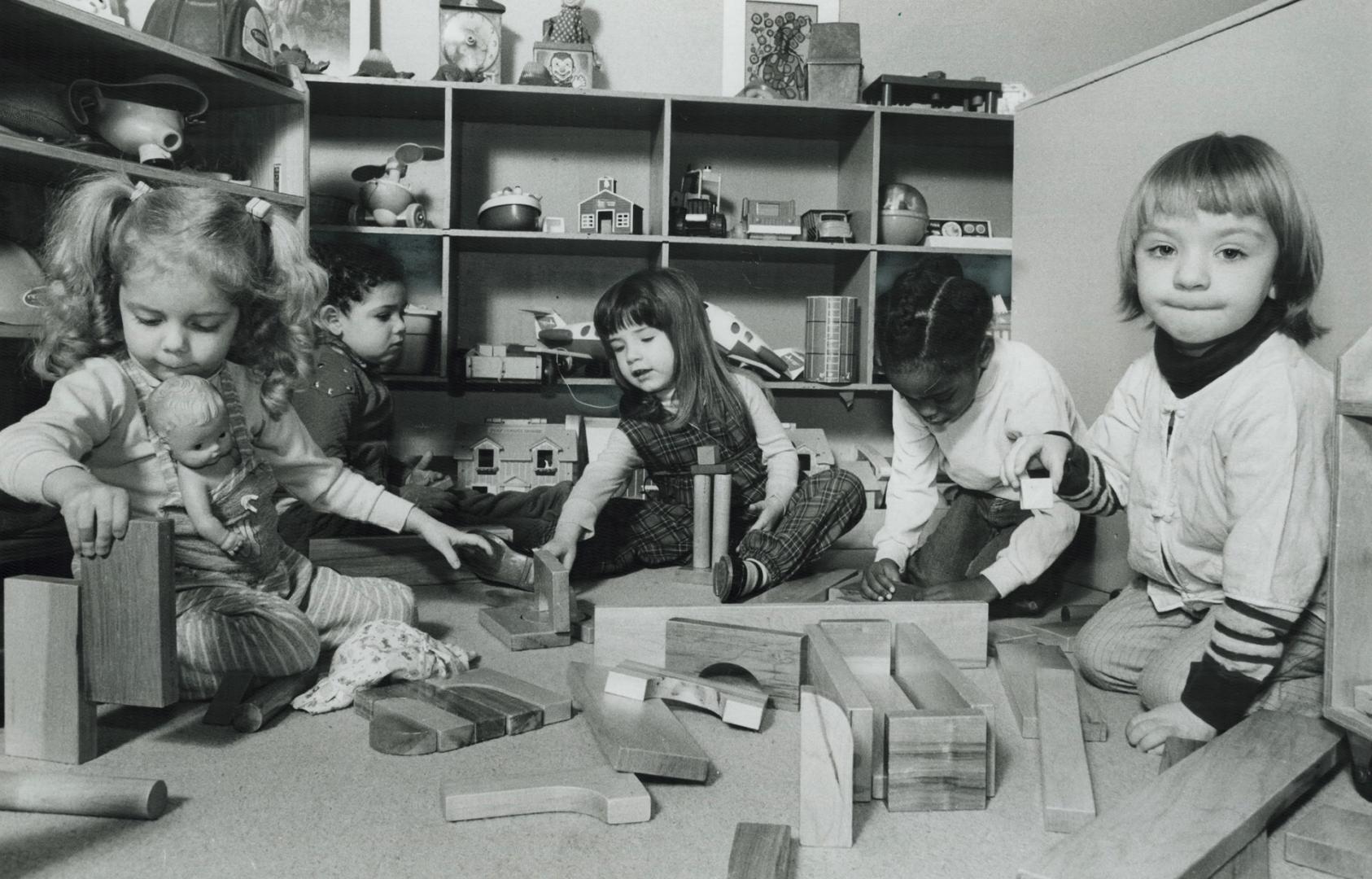 shop. Middle, children at Snowflake Parent-Child Centre play with the fruit of the workshop's labors. Left [Incomplete]