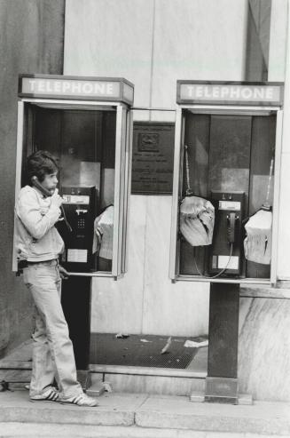 Peek-a-boo: Bell Canada says phone booths at corner of Yonge and Adelaide don't block view of Fleming memorial plaque, and there's no need to move them