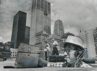 Metro -- A Building Boomtown, Bell Telephone cable splicer Bill Liberty works in a manhole at the O'Keefe Centre on Front St