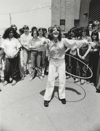 Lynne Pelletier, left, and Josee Daniel demonstrate prowess with a hula hoop after a barbecue at Smithfield Middle School