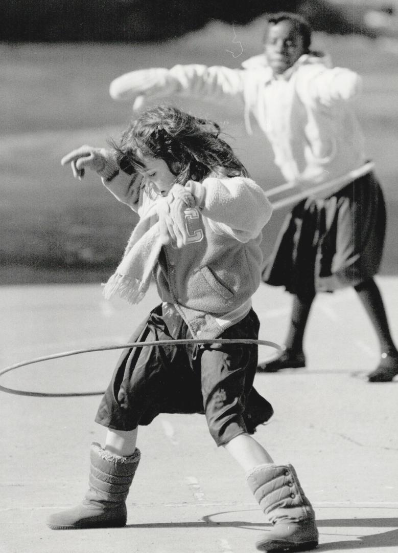 Hula hoops are just one of the fun things to enjoy next week during school break for Katy corcoran, 7, and Jane Mulera, in background