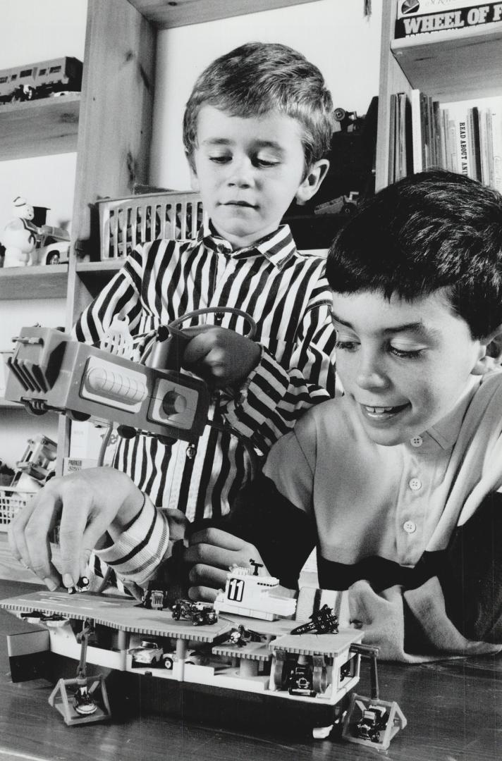 Playful pair: Paul Matthews, 8, checks out the Micromachine Aircraft Carrier while brother Ian 5, examines the Ghost Trap