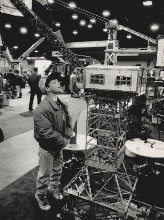 Sidewalk Superintendent: Shawn VanGestel, 10, of Stratford looks at a toy crane, made by Ed Barclay of Owen Sound, at the Canadian Construction show