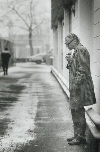 Waiting for food: Alone and pensive at the Scott Mission yesterday -- this man was just one of the 1,000 people hoping to get a free hamper that would provide Christmas dinner