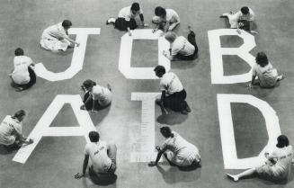 Big project, big sign: Students prepare a huge sign for the Job Aid blitz starting tomorrow in Varsity Arena