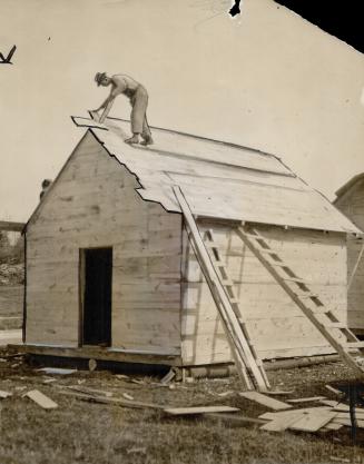 Workmen busy on construction of shacks in one of the camps along North Bay-Mattawa section of trans-Canada highway, to where some of Toronto jobless have gone