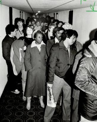 Hopeful line: A group of people line up in Toronto looking for work