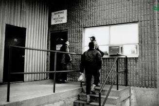 Lucky ones: Three men who managed to get a job for the day file into a west-end warehouse