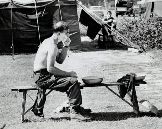 Shaving in open air and from a basin-no hot and coled running water here-is Cpl