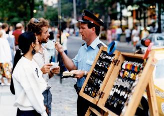 Metro Constable Alan Galbraith issues a $ 103 ticket to vendors Randy Tyrrell and wife April in Yorkville last night