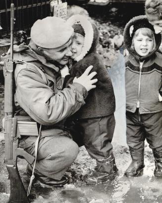 Lance-Cpl, Andre Paquet, 29, among the first members of the Royal 22nd Regiment to leave Quebec City for Cyprus yesterday, gets a farewell kiss from h(...)