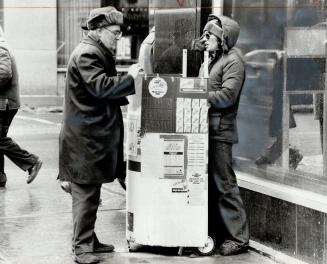 Lottery-ticket vendor Terry Nicols makes a sale in downtown Toronto