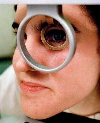 Eye-to eye, Grade 13 student Joanne Muzzin, at the Ontario Science Centre's Mindworks exhibition, looks through an eye tracker which allows her to watch how her eyes work