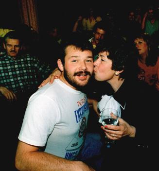 Family reunited: Gary Clarke, who recently returned from the Persian Gulf, gets a kiss from his mother, Anna Marie, as relatives celebrate