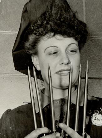 Points count with Dorothy Hyslop, Toronto, CENTRE, inspecting bayonets for the No