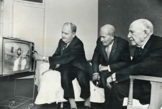 World War I Flyers attending a reunion in Toronto, their eyes pinned to a television set as they watch preparations for the splashdown yesterday of th(...)