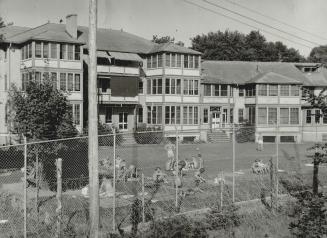 Barbed wire and floodlights bar the way to, Here is the Northern Ontario prison camp from which Lieut