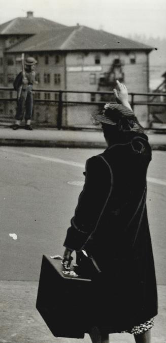 A Japanese woman waves at a distant window