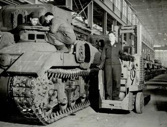 Operating an electric Donkiey Engine in Canada's Ram tank factor, this girl is doing a man-sized job of hauling heavy equipment. She steers her way do(...)