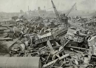 Tanks from World War No. 1 are part fo the big scrap pile in this Baltimore, Md., salvage yard. The steel will go to mills where it will be reproduced(...)