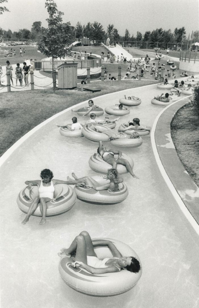 Traffic jam, The water course at Sunshine Beach Water Park in Brampton gets a little clogged yesterday as people take to their water rings to relax and beat the heat