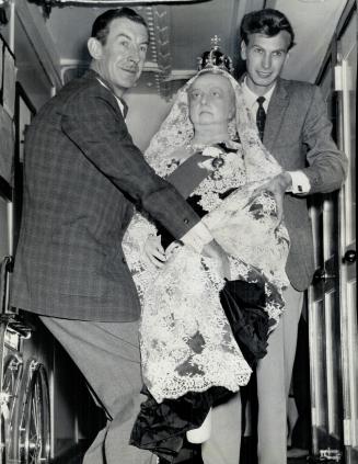 Manhandling a 'Queen', Stanley Deroy and son, Derek, struggle down ship's passageway with wax figure of Queen Victoria which arrived in Toronto Saturd(...)