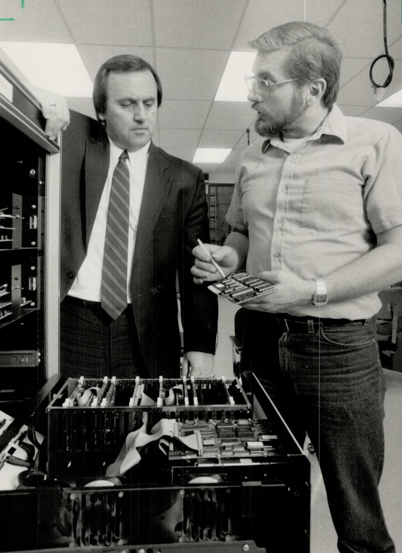 Coming up Sunny: National sales manager Roger Davies, left, and production supervisor Thomas Jowett look over part of Canadian Applied Technology's environmental monitoring system