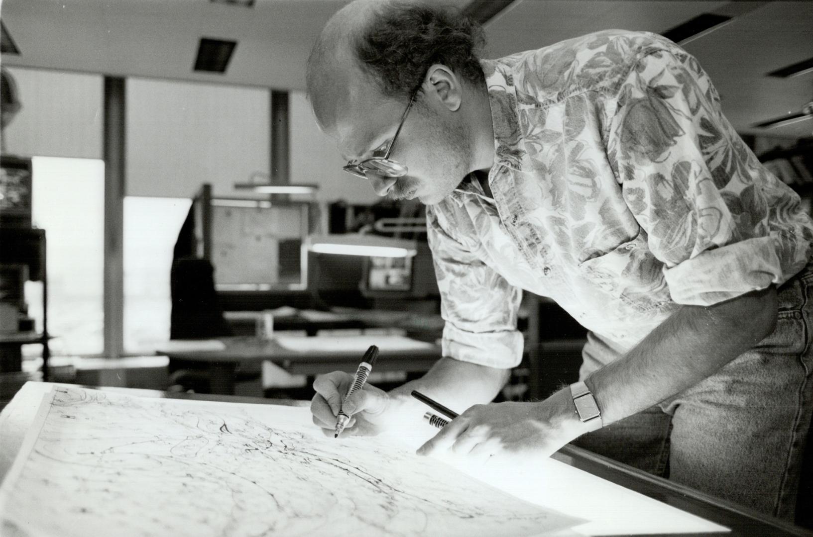 Charting the Path: Jack Dunnigan, of the Ontario Weather Centre at Pearson International Airport, tracks a storm on maps at his light table