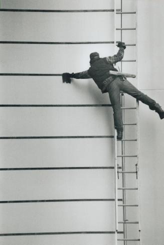 Balancing act, A window cleaner hangs from his cold perch as he scrubs grime from the gaps in the walls of an office building at the corner of King an(...)