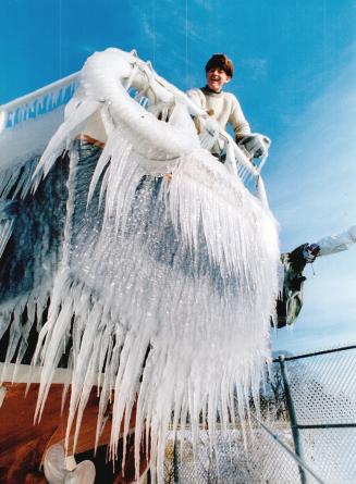 John Rutherford checks out nature's artwork on his schooner, Lochinvar, at the Toronto Sailing and Canoe Club yesterday