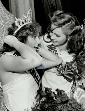 In the queen's court, Miss Mississauga, Kathy Vykysaly, 19, right, congratulates the new Miss Canada, Terry Mackay, 18, of Calgary