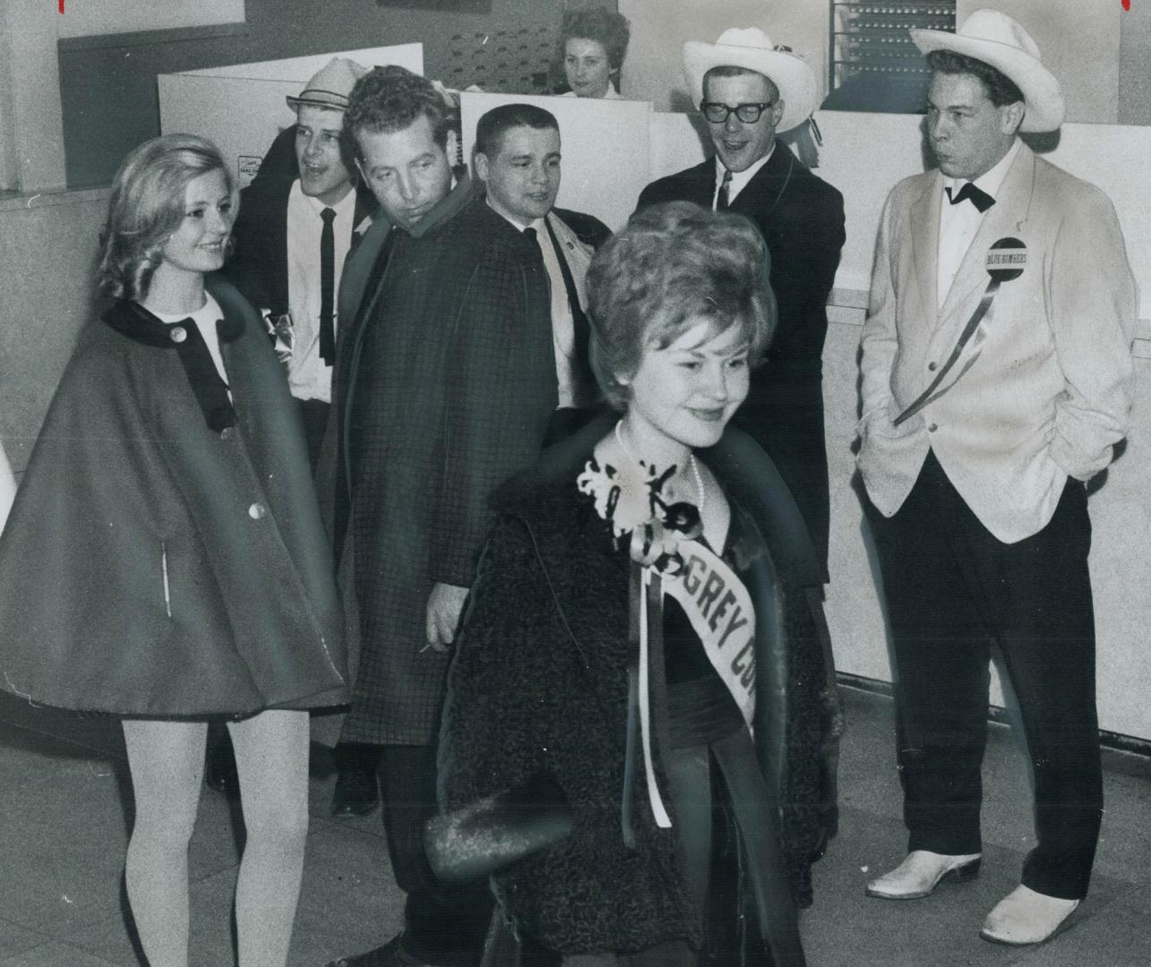 Missa Ottawa Rough Rider, Renata Pikelis (left) and Ingrid Osmolowsky, Miss Grey Cup 1962 and Miss Grey Cup 1961 get wolf whistles from appreciative fans