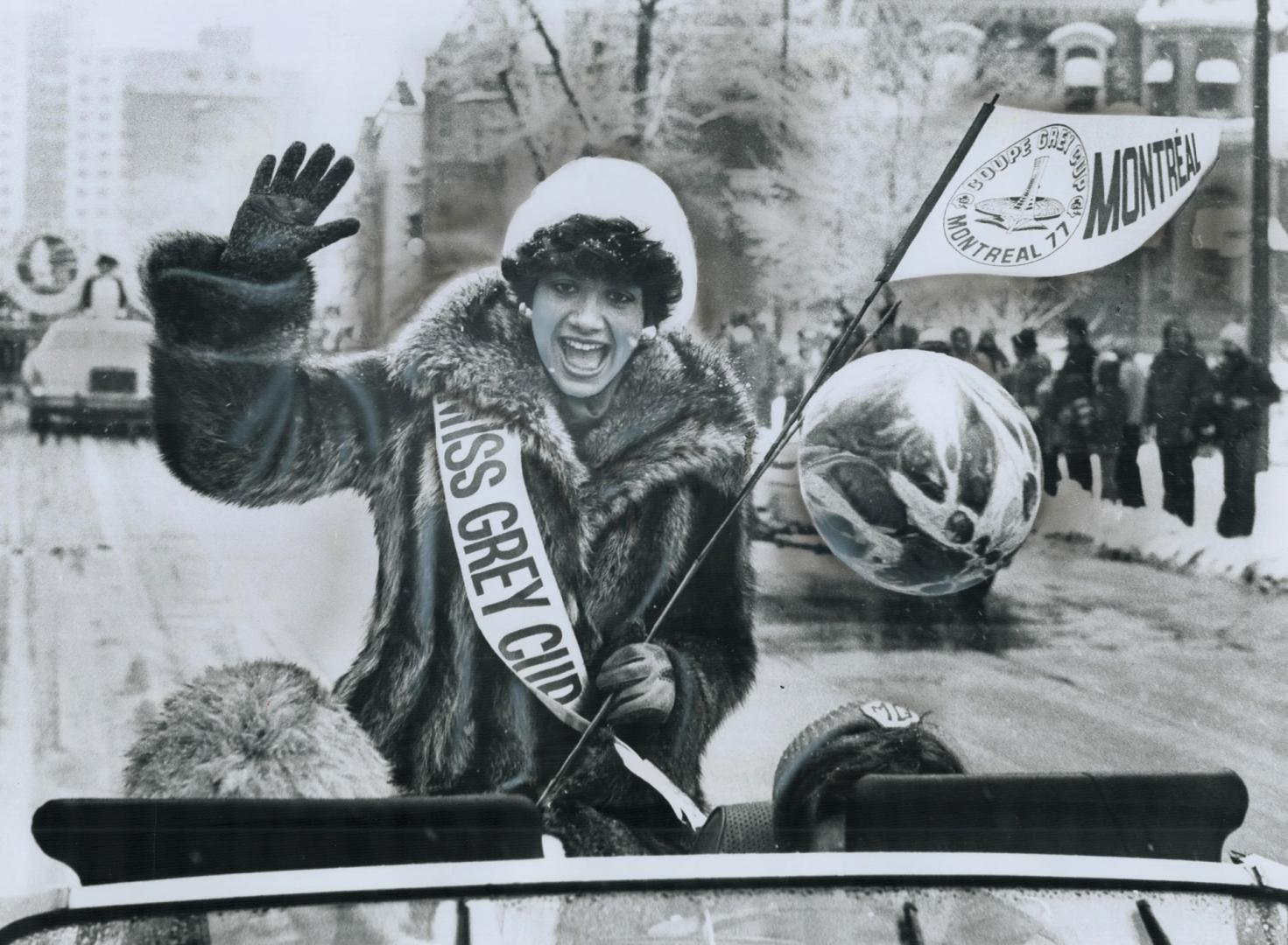 Already a winner, Miss Montreal Alouette - Louise Mondoux, 22, waves her Miss Grey Cup greeting