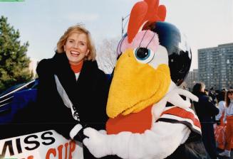 Miss Grey Cup Karen Harrison, a 35-year-old mother of two, travels with the Ottawa Rough Rider mascot at the Grey Cup Parade in Ottawa Yesterday. Page(...)