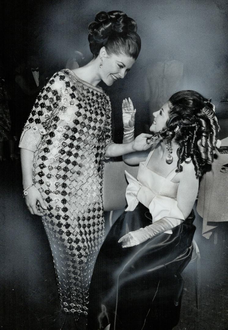 15-pound centennial gown worn by Miss Toronto, Shirley-Ann Macdonald (left), drew admiring comments from guests at last night's Centennial Ball in Roy(...)