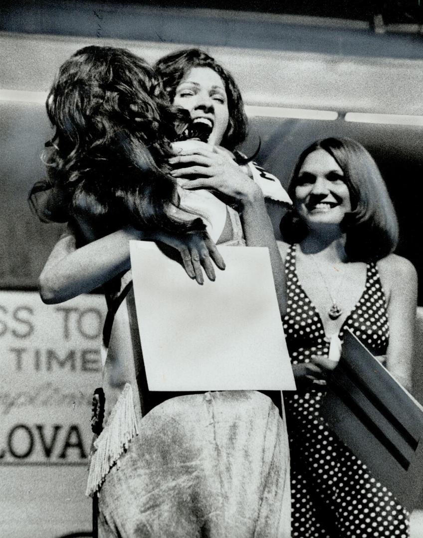 Miss Toronto-Colleen Embree, 23-is hugged by last year's winner, Pat Mazurick, when her victory was announced Saturday night. Miss Embree, a 5-foot-8-(...)