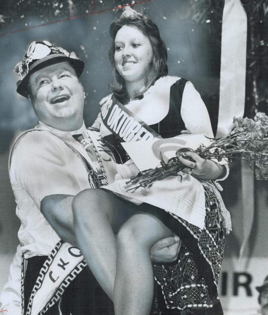 Oktoberfest queen gets a lift, Mr. Oktoberfest, Armin Hau, had his hands full last night at the International Centre on Dixon Rd. where Dana Beyer, 17(...)