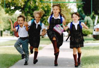 Look out, World: Brian, Pamela, Laura and Nicole Holtvluewer are raring to go to school today