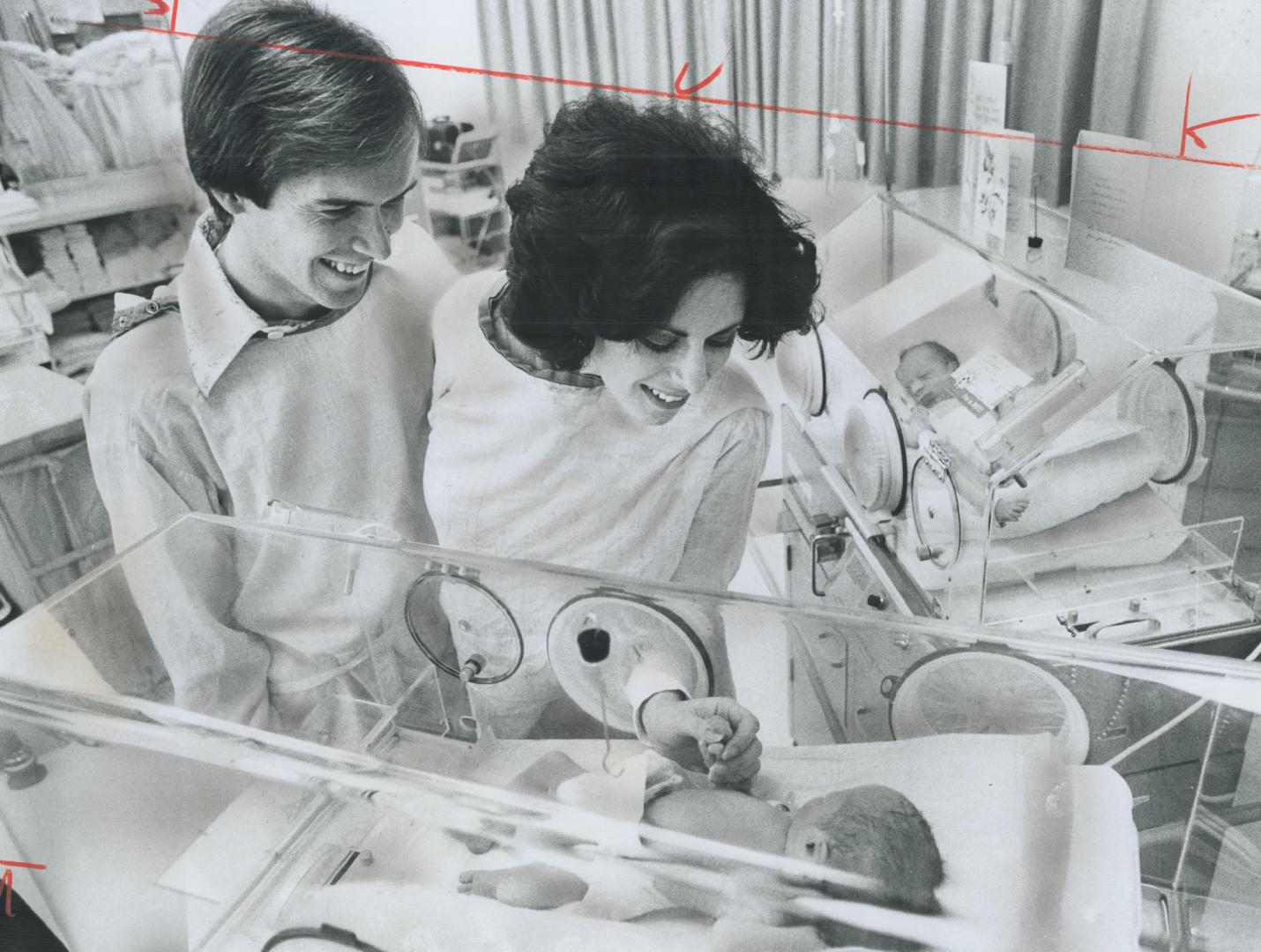 Twins make it a triple celebration, Proud parents Paul Barker, 26, and his wife, Barbara, 23, of Downsview, admire their twin sons born at North York General Hospital on Thursday night