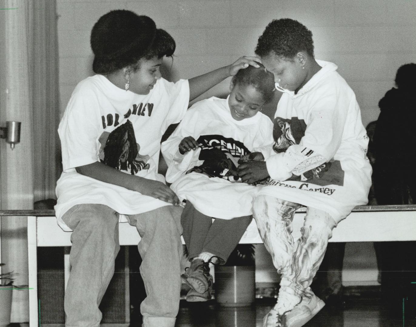 Day of learning: Jennifer Beckford, 9, left, Shanique Francis, 6, and Stacey Gordon, 10, check out T-shirts commemorating Black History month